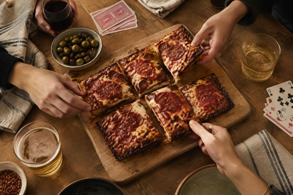 Pizza squares shared around a game night table